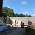 Under construction, stone clad road-facing facade