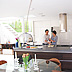 Modern open plan living: kitchen area with outdoor illusion mural lit by glass roof to open up the space
