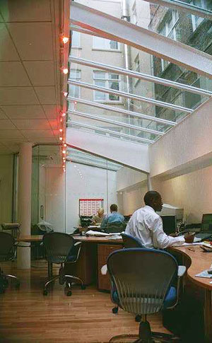 Office development: light well lit from glazed facade