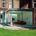 Contemporary glass extension to Grade 2 listed mansion block in Hampstead