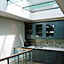 Kitchen lit from glass floor of the roof terrace above